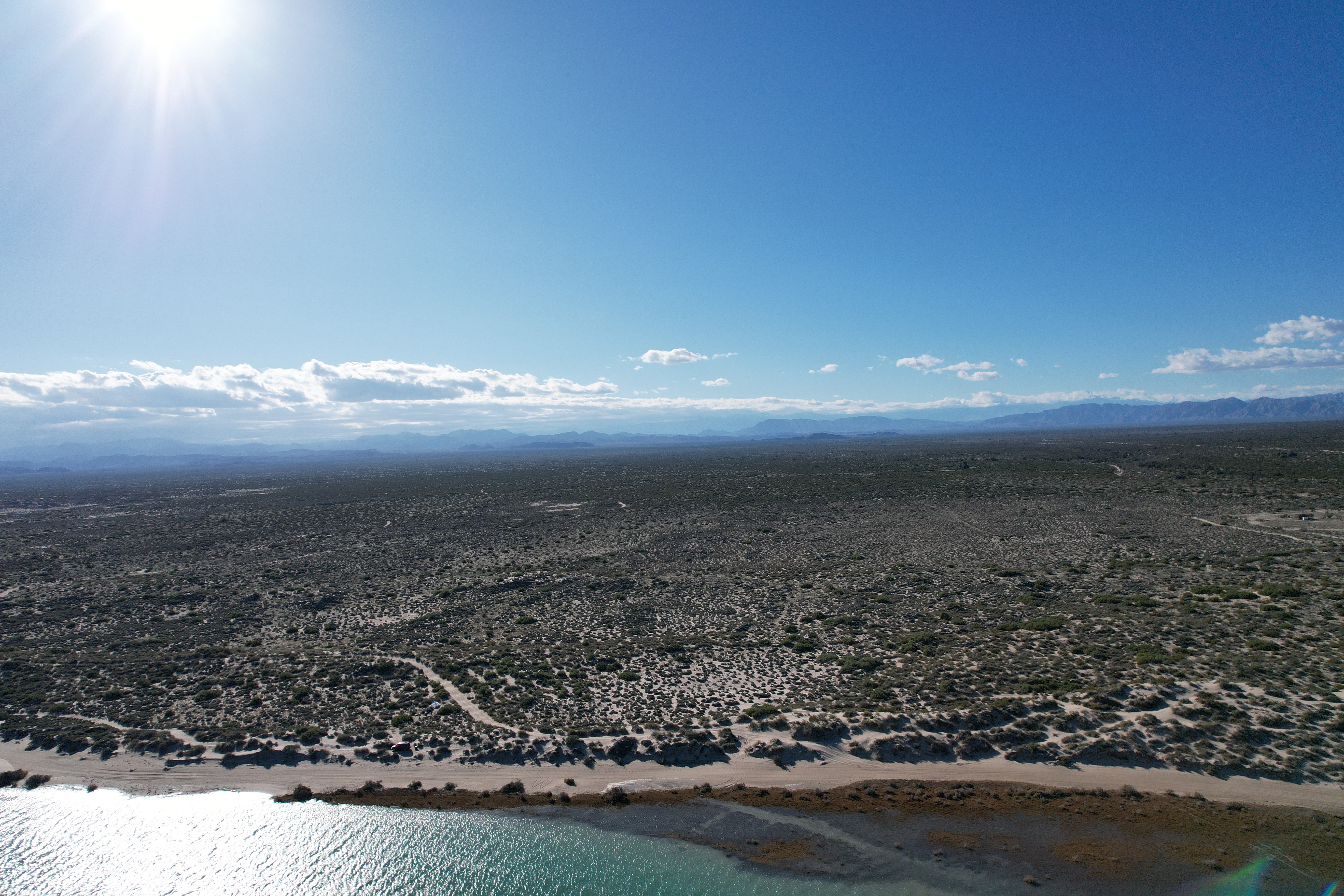 Aerial view showing desert land and water near Percebu Lagoon